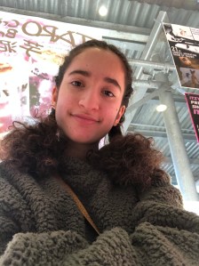 Narges Anzali looks down into the camera with a smile.